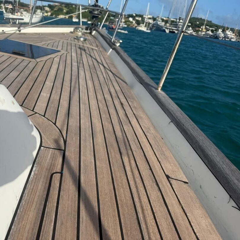 Restored genuine teak foredeck on a sailing yacht in the harbour