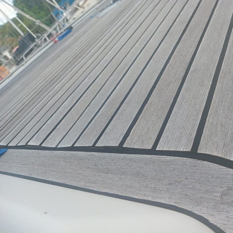 Close-up of margin and king plank detail in aged synthetic teak